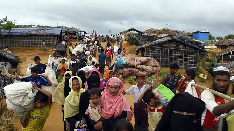Rohingya refugees exhausted streaming off boats arriving on the beach ,old photo /collected